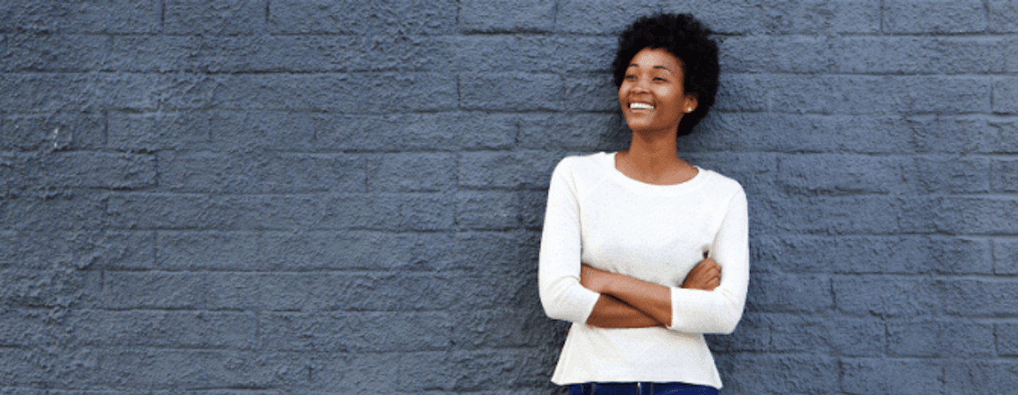 Black woman smiling with arms crossed