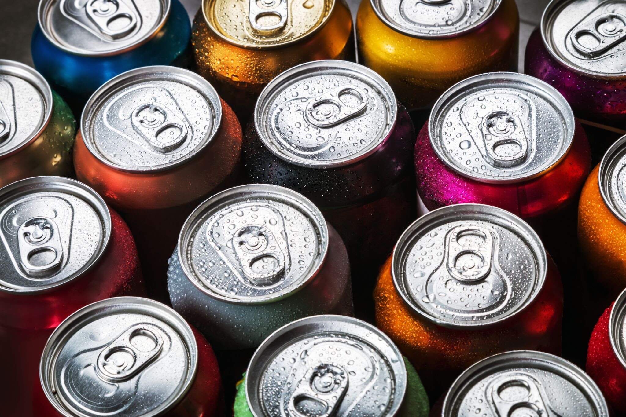 Sixteen cans of soda, shown from above so you can mostly only see the silver tops